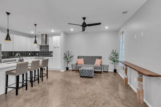 a living room with furniture and kitchen view