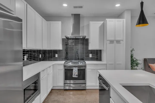 a kitchen with stainless steel appliances a stove and a refrigerator