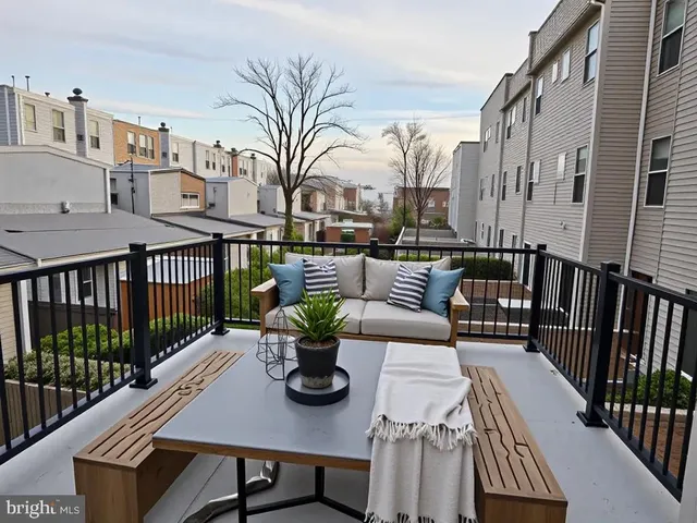 a view of a patio with couches table and chairs and wooden floor