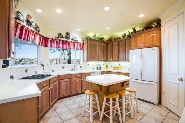 a kitchen with stainless steel appliances kitchen island granite countertop a sink and cabinets