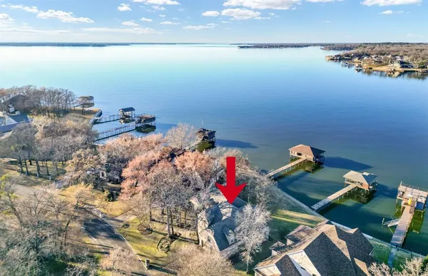 a view of a house with a yard and large trees