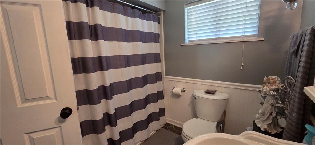 551 Muse-Bishop Road McDonald, PA 15057 - Photo 13 of 38 a white toilet sitting next to a shower curtain