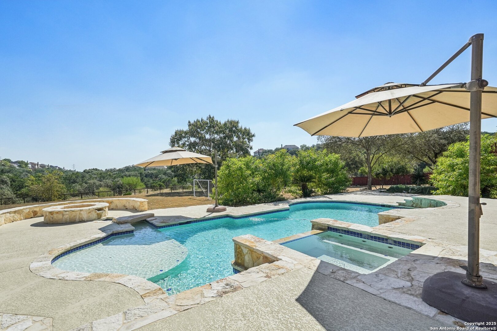 718 Ruidosa Downs Helotes, TX 78023 - Photo 40 of 50 a view of a swimming pool with a patio and a yard