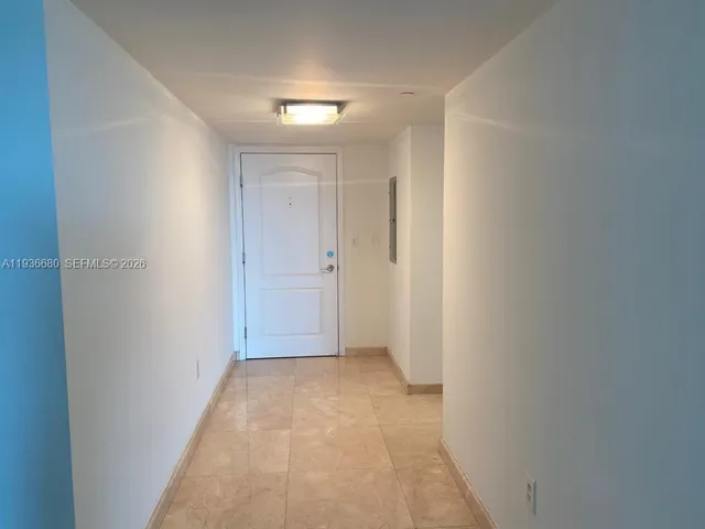 a kitchen with granite countertop white cabinets and black appliances