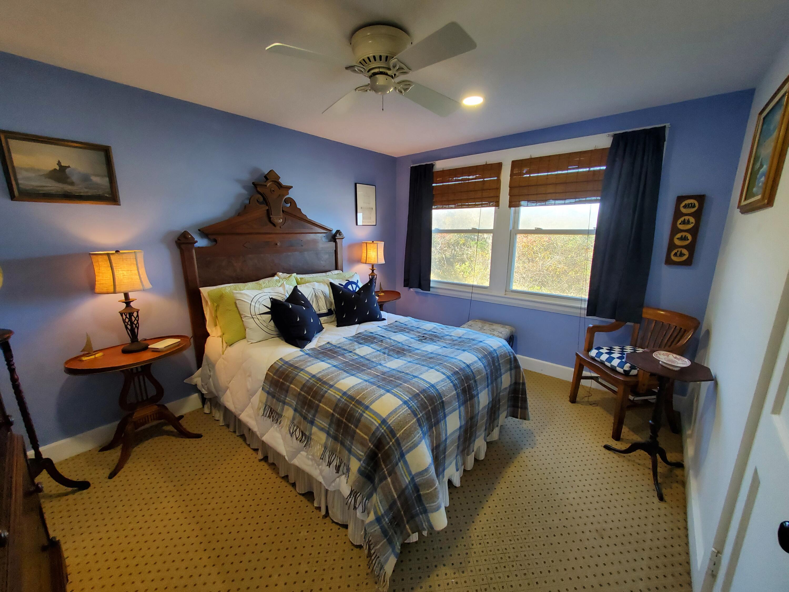 157 Brownell Road Eastham, MA 02642 - Photo 22 of 34 a bedroom with a bed and a chandelier