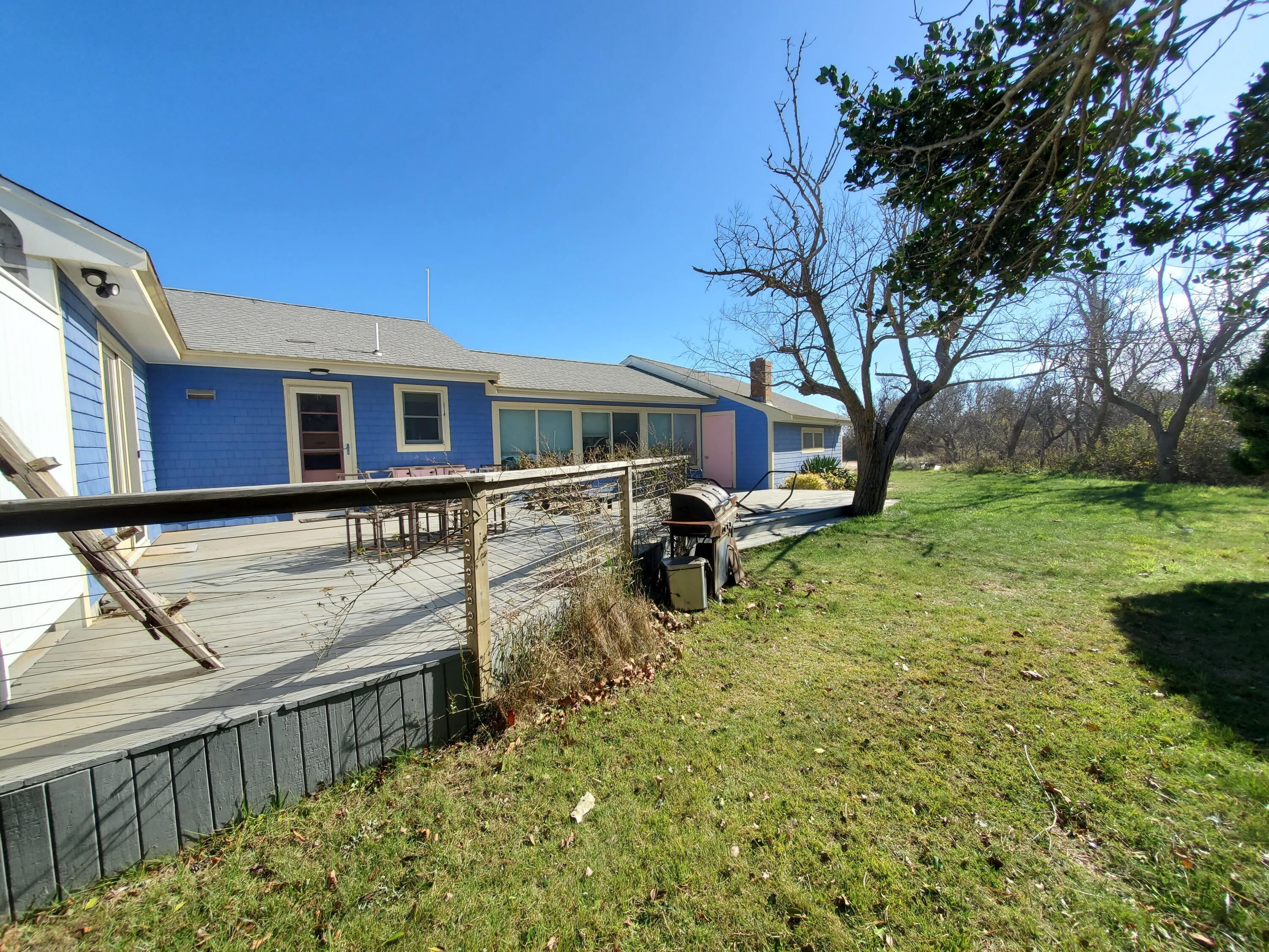 157 Brownell Road Eastham, MA 02642 - Photo 29 of 34 a backyard of a house with barbeque oven and trees