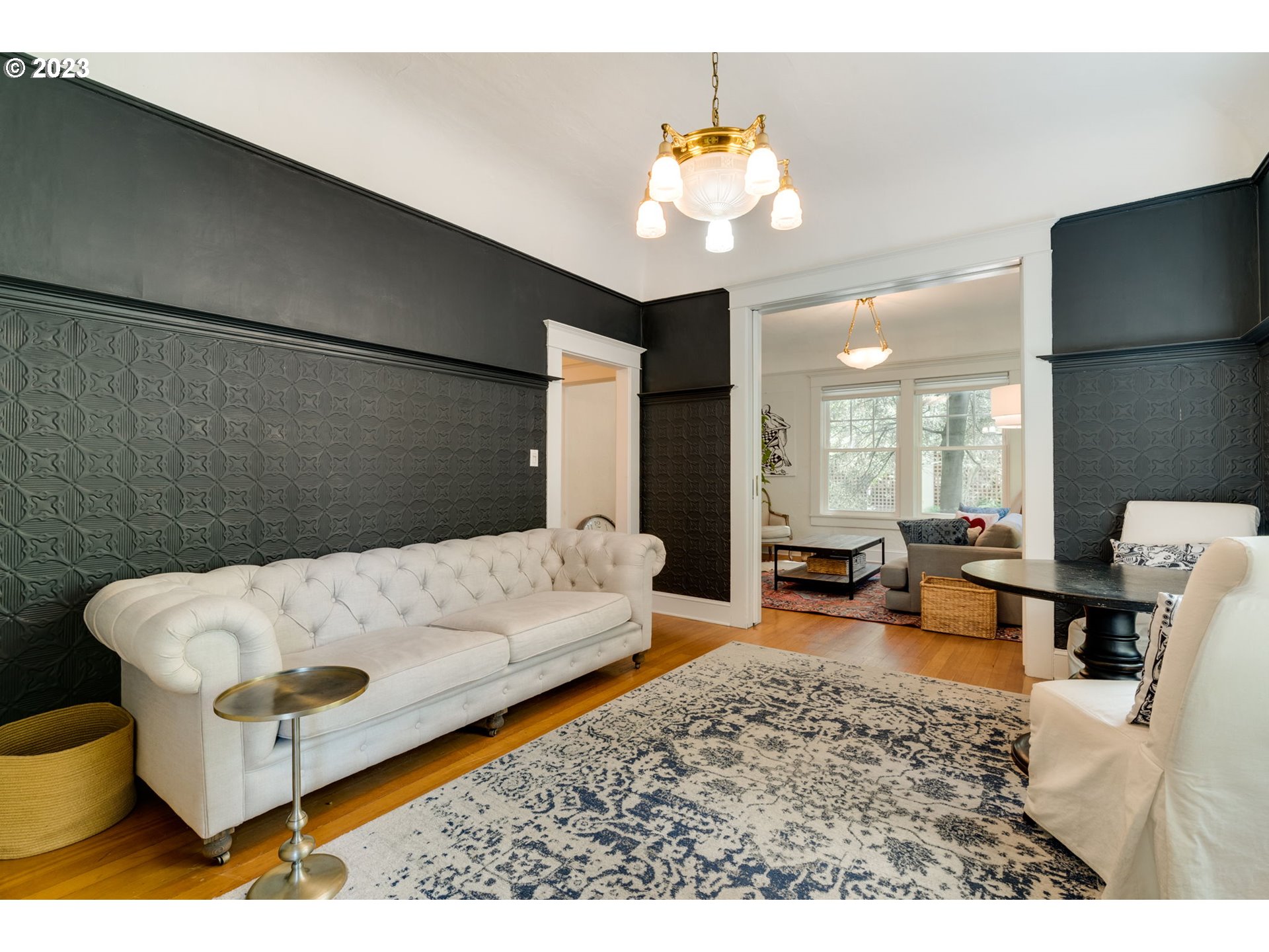 2129 Northwest Northrup Street, Unit 1 Portland, OR 97210 - Photo 17 of 37 a living room with furniture and a chandelier