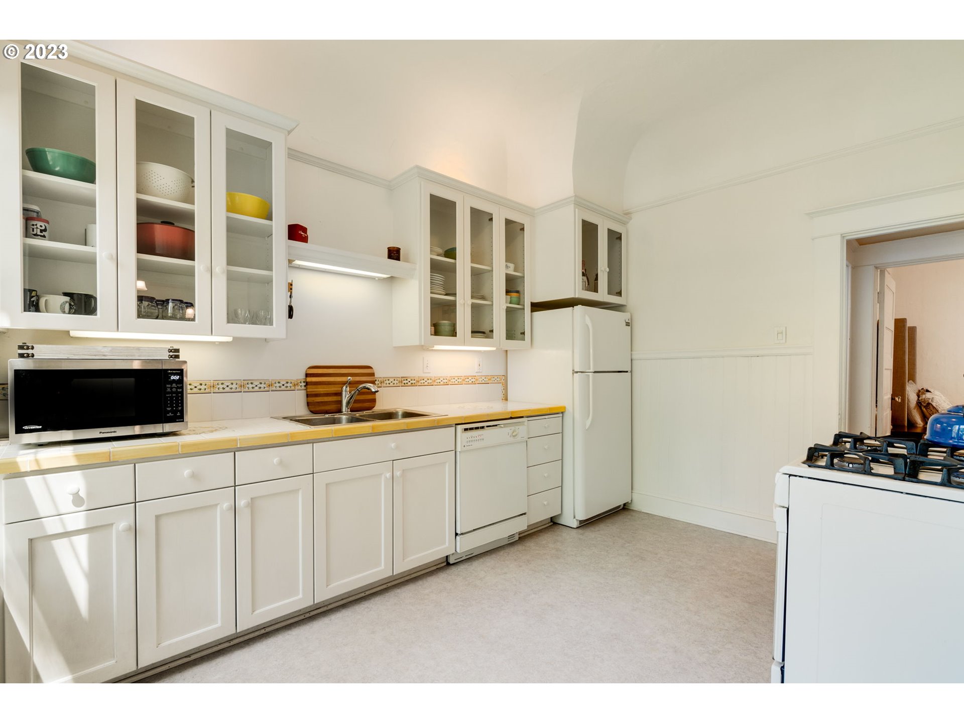 2129 Northwest Northrup Street, Unit 1 Portland, OR 97210 - Photo 22 of 37 a kitchen with stainless steel appliances a sink a stove and a refrigerator
