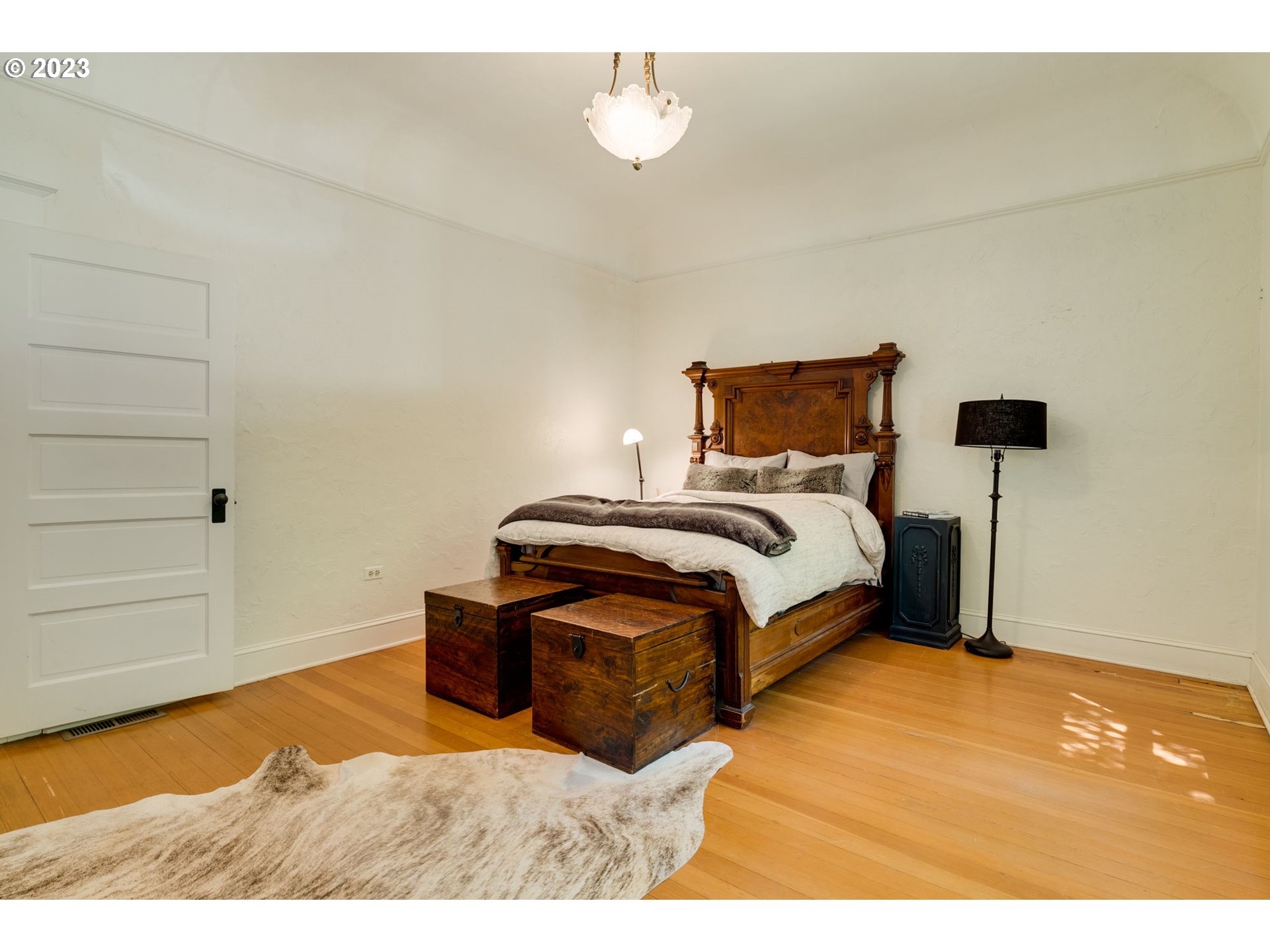 2129 Northwest Northrup Street, Unit 1 Portland, OR 97210 - Photo 34 of 37 a bedroom with a bed and wooden floor