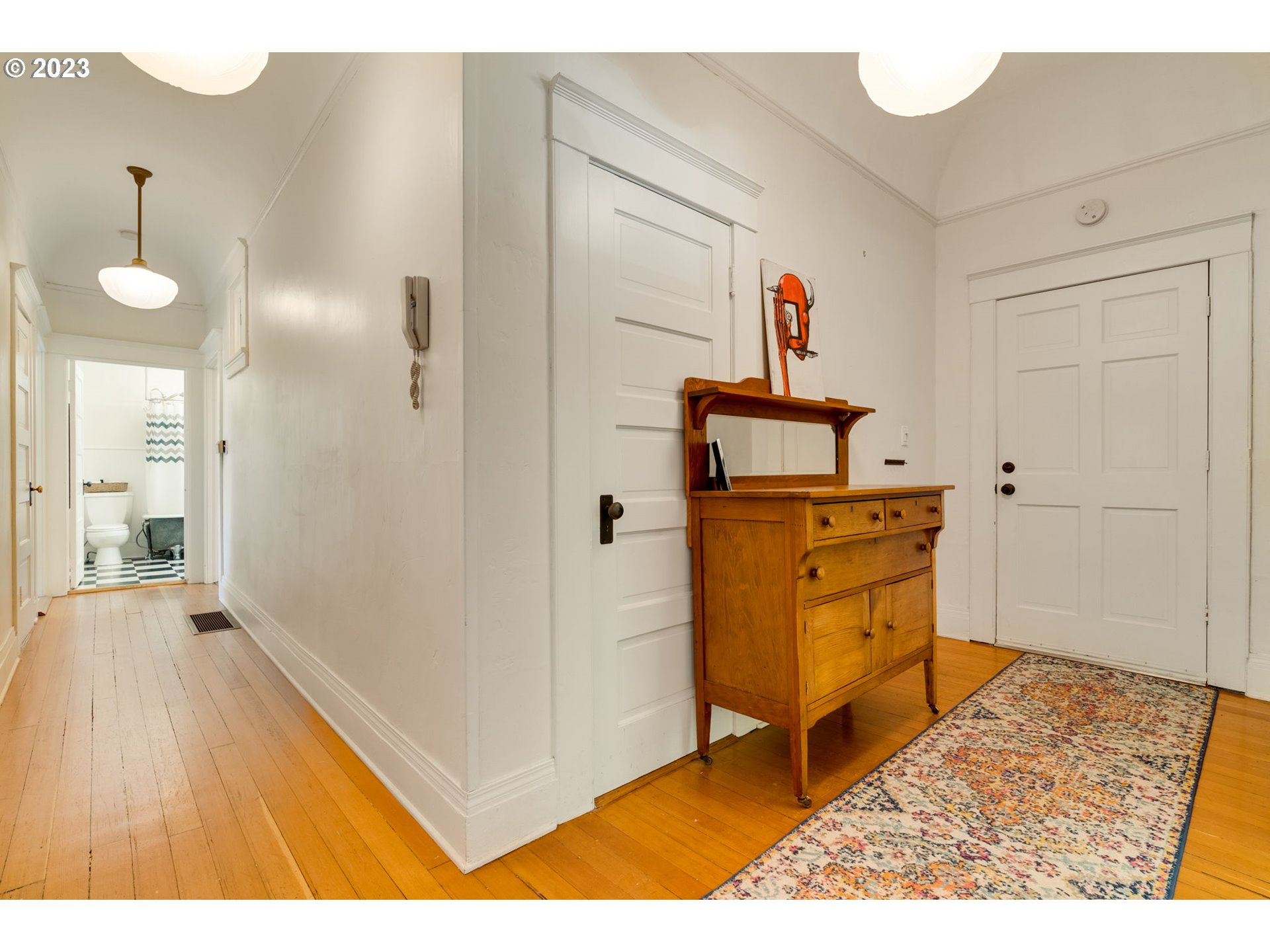 2129 Northwest Northrup Street, Unit 1 Portland, OR 97210 - Photo 7 of 37 a view of a hallway with wooden floor and furniture