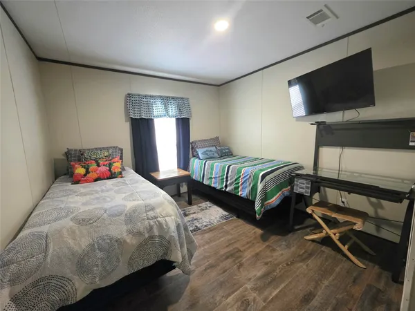 a bedroom with a bed and a flat screen television