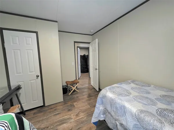 a bedroom with a bed and a mirror