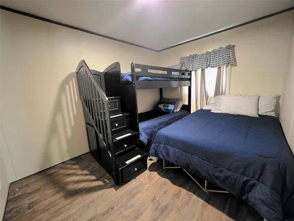 a bed room with a bed and a television