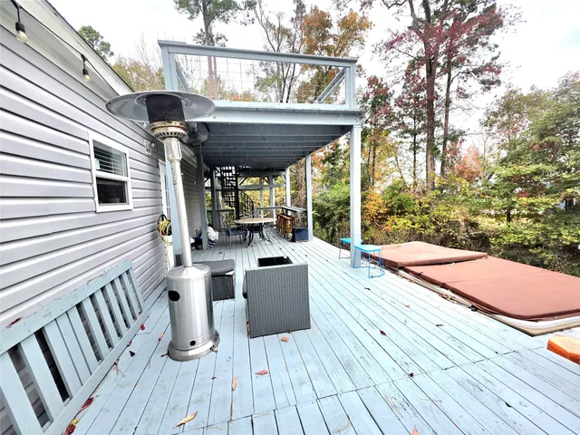 a view of roof deck with wooden floor and seating space