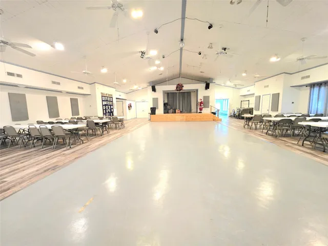 a large kitchen with a large counter top appliances and cabinets