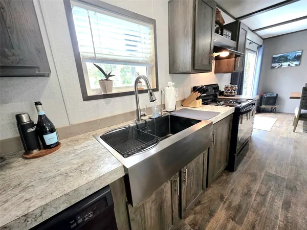 a kitchen with a sink stove and cabinets