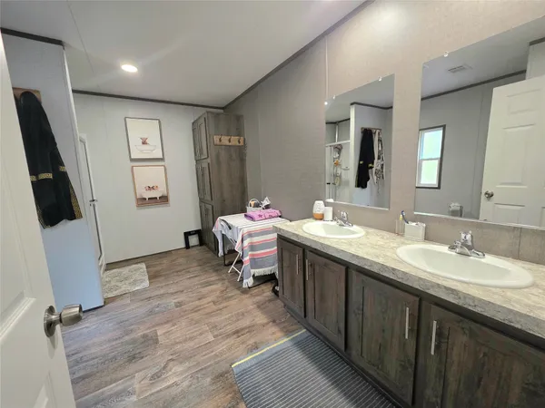 a bathroom with a double vanity sink mirror and toilet