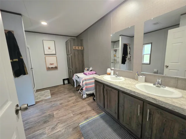 a bathroom with a double vanity sink mirror and toilet
