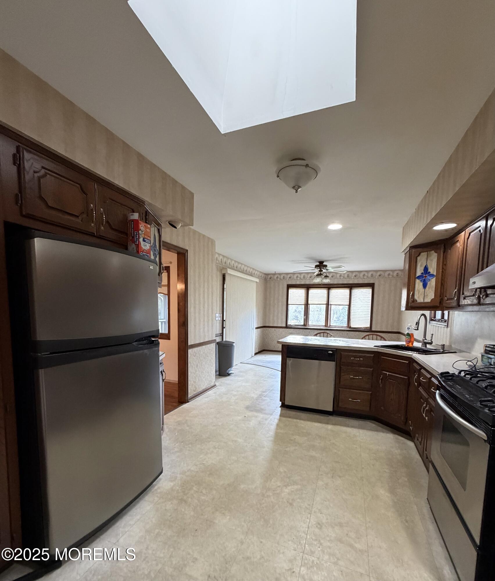 48 Homestead Road Freehold, NJ 07728 - Photo 3 of 22 a kitchen with a refrigerator and cabinets