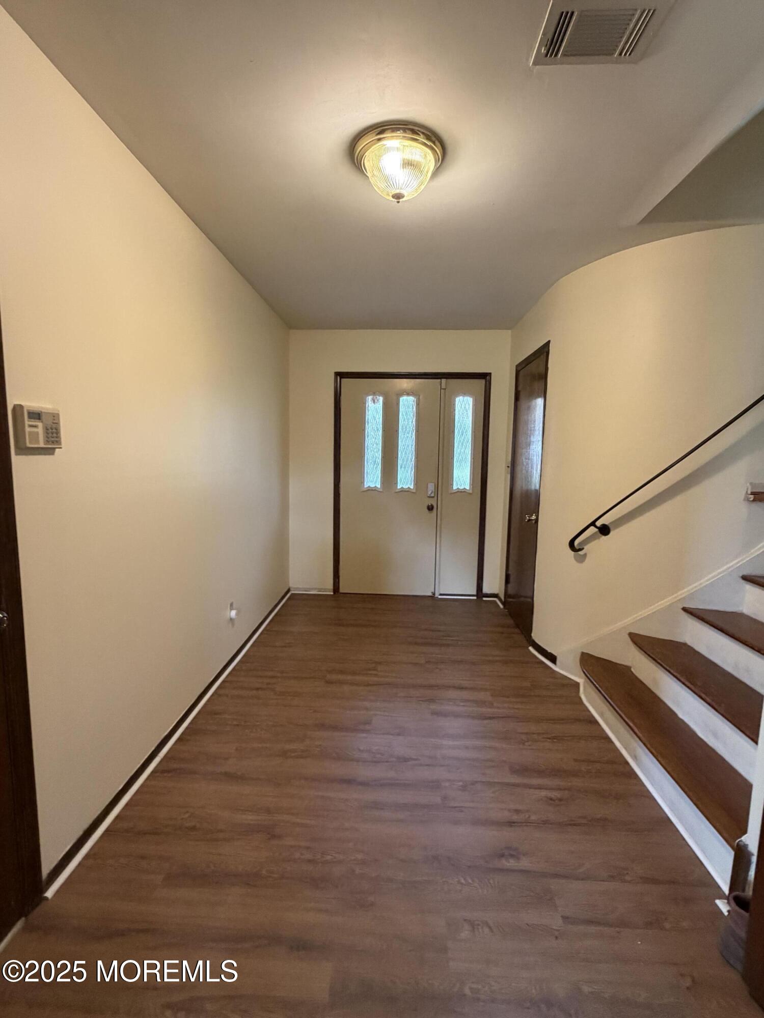 48 Homestead Road Freehold, NJ 07728 - Photo 8 of 22 a view of an empty room with wooden floor and a window