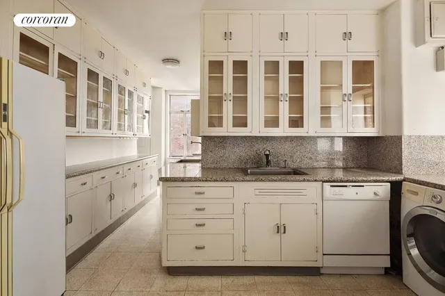 a kitchen with a sink a stove and a microwave