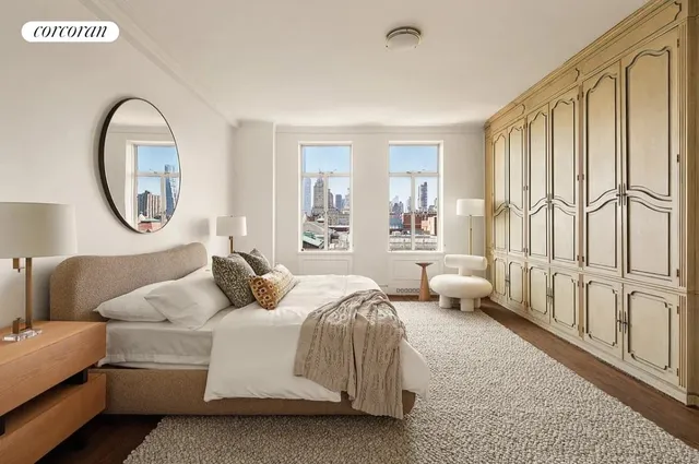 a bedroom with a bed and a large window