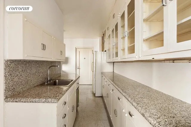 a kitchen with cabinets appliances and a window