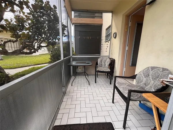 a balcony with furniture and a garden