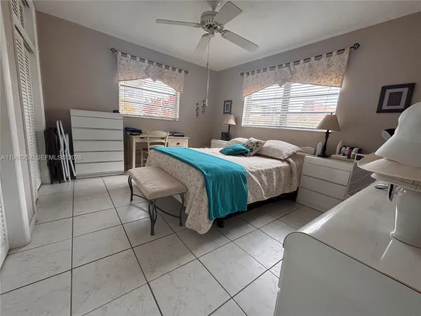 a bedroom with a bed and a dresser in it