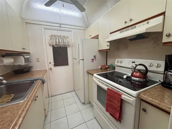 a kitchen that has a sink and a stove