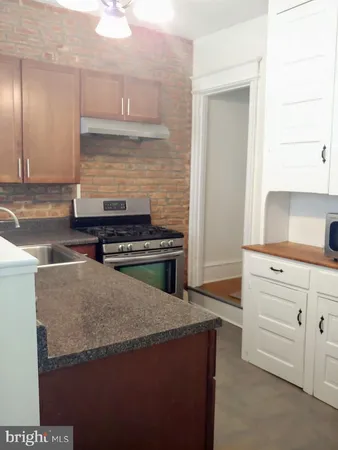 a kitchen with a stove and a sink