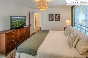 a bedroom with a bed and a flat screen tv