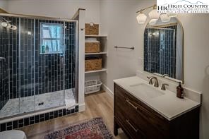 811 Pine Ridge Road Banner Elk, NC 28604 - Photo 24 of 35 a bathroom with a sink a shower and a mirror
