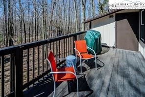 811 Pine Ridge Road Banner Elk, NC 28604 - Photo 27 of 35 a balcony with chairs and wooden fence
