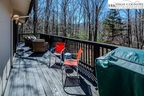 811 Pine Ridge Road Banner Elk, NC 28604 - Photo 28 of 35 a view of balcony with wooden floor potted plants and outdoor seating