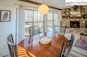 811 Pine Ridge Road Banner Elk, NC 28604 - Photo 9 of 35 a dining room with furniture a fireplace and wooden floor