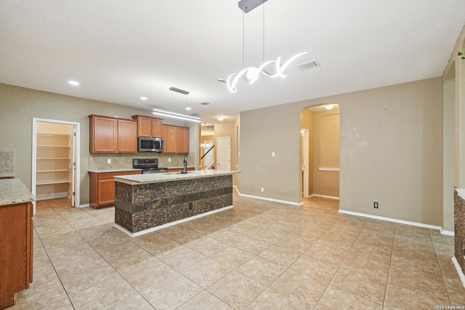9536 Gold Stage Road San Antonio, TX 78254 - Photo 11 of 39 a view of kitchen with granite countertop cabinets and refrigerator