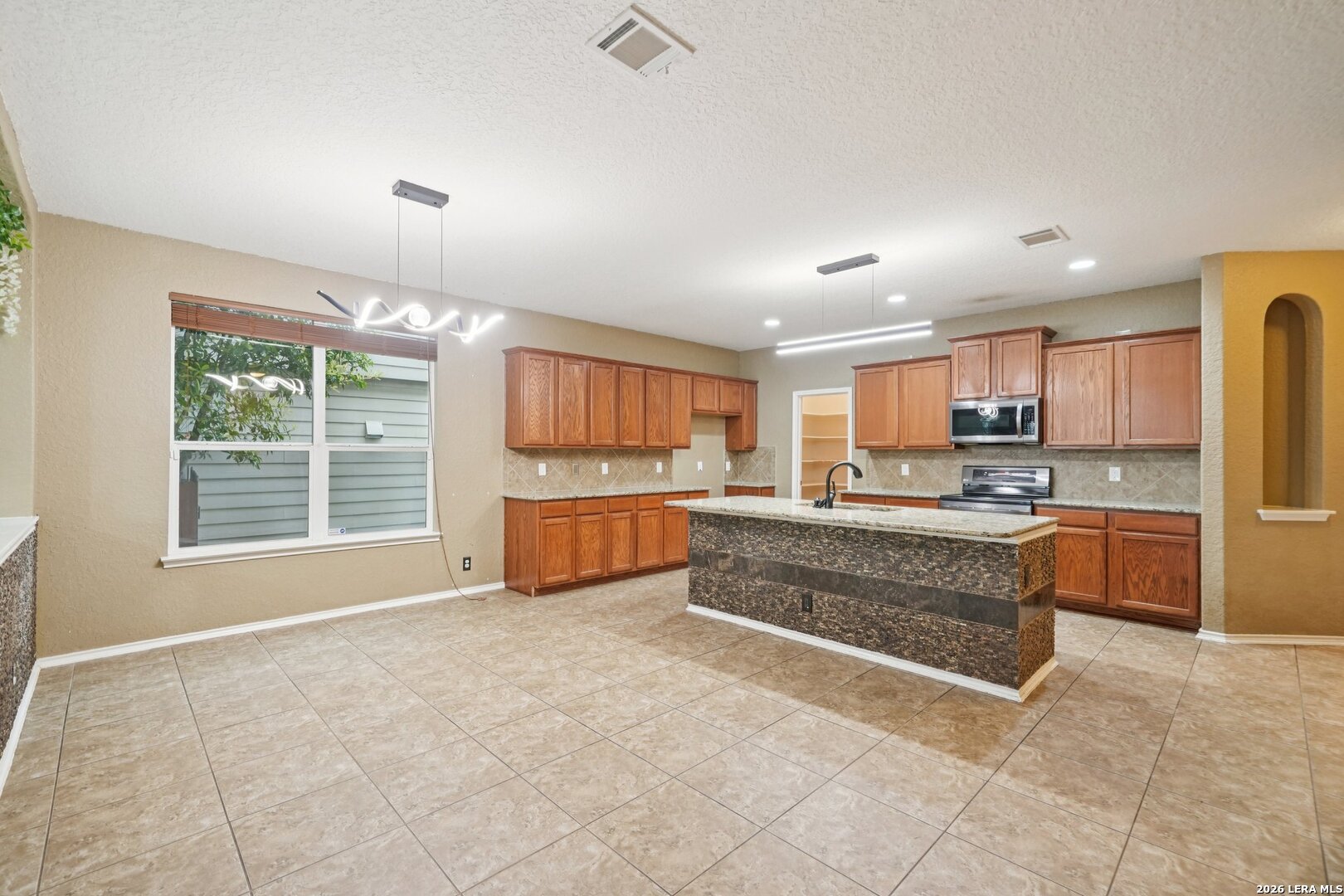 9536 Gold Stage Road San Antonio, TX 78254 - Photo 12 of 39 a view of kitchen with stainless steel appliances granite countertop a stove and a refrigerator