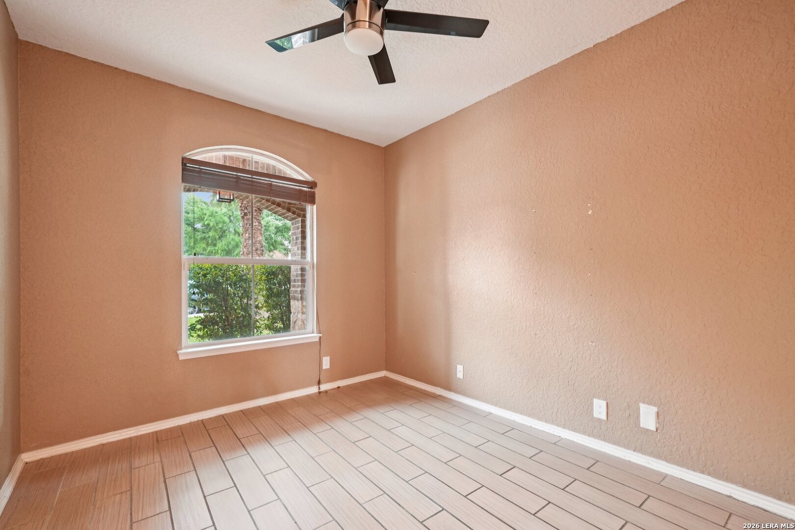 9536 Gold Stage Road San Antonio, TX 78254 - Photo 17 of 39 an empty room with a window and a ceiling fan