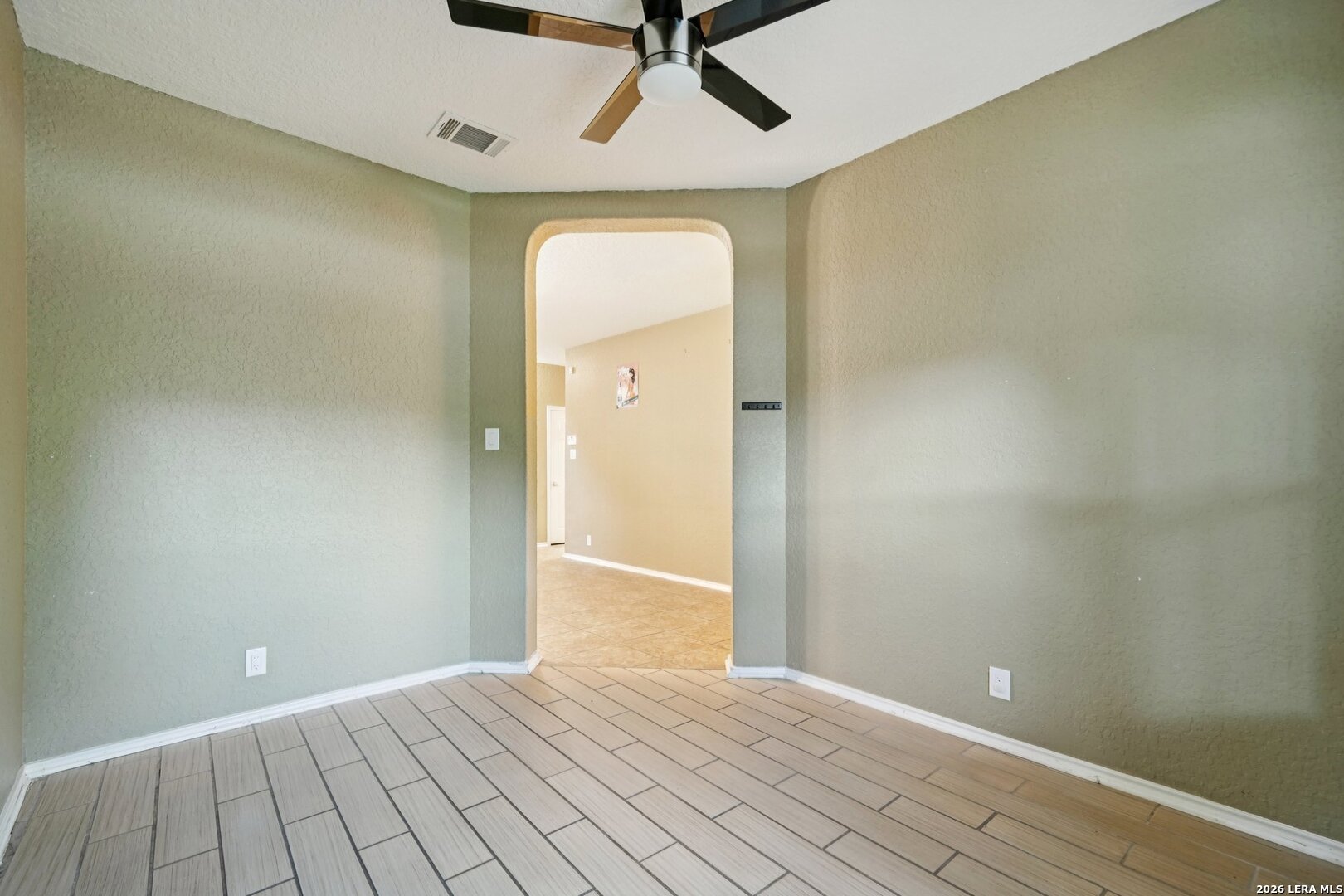9536 Gold Stage Road San Antonio, TX 78254 - Photo 18 of 39 wooden floor in an empty room with a window