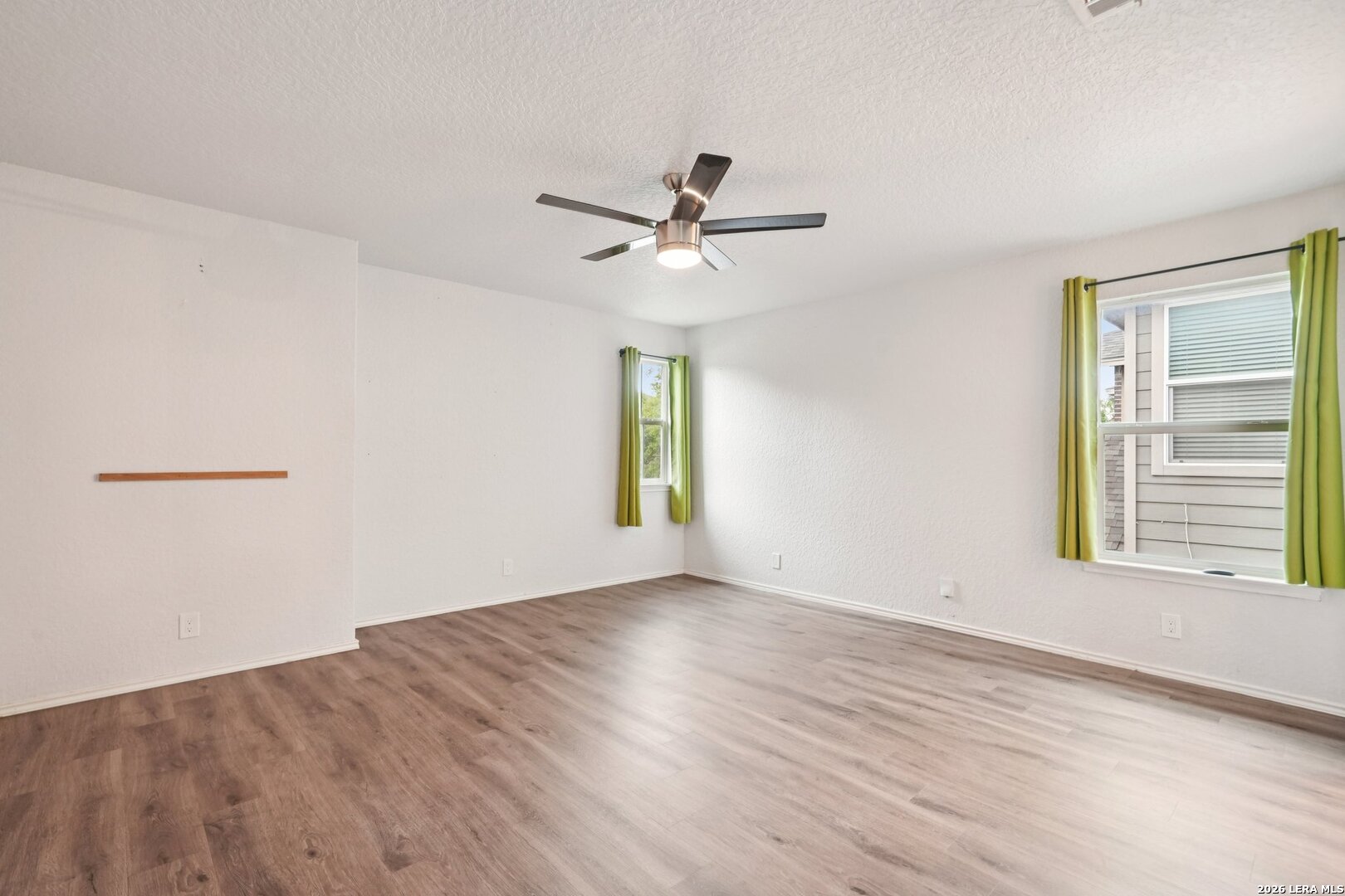 9536 Gold Stage Road San Antonio, TX 78254 - Photo 22 of 39 wooden floor in an empty room with a window