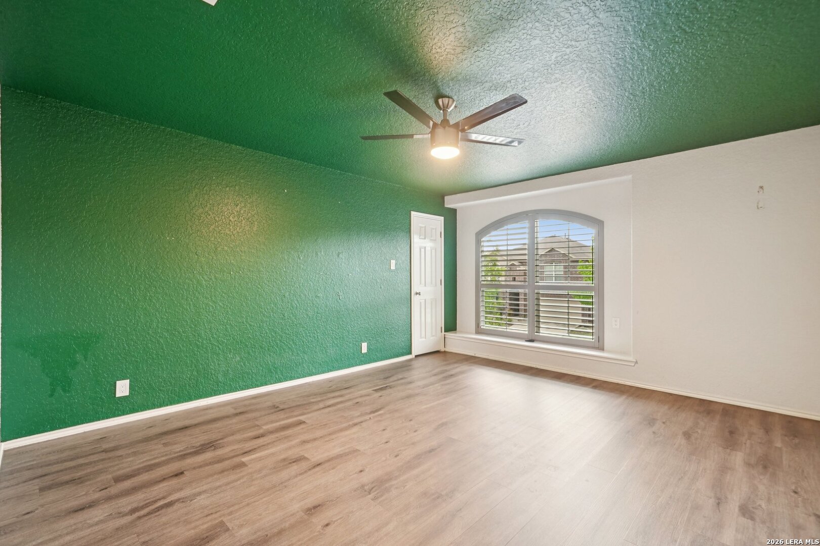 9536 Gold Stage Road San Antonio, TX 78254 - Photo 24 of 39 a view of empty room with wooden floor and fan