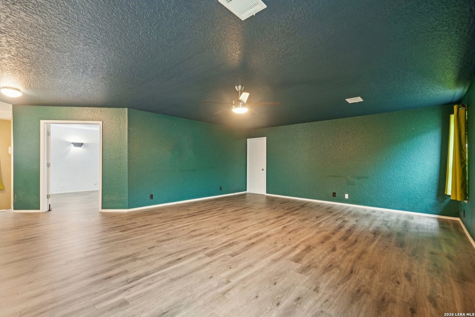 9536 Gold Stage Road San Antonio, TX 78254 - Photo 26 of 39 a view of a big room with wooden floor and windows