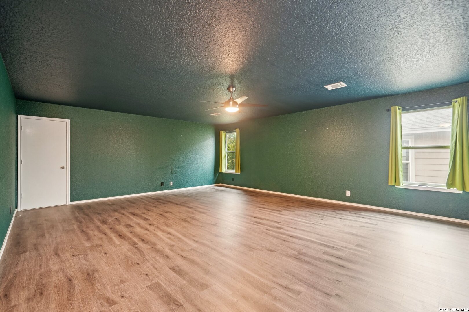9536 Gold Stage Road San Antonio, TX 78254 - Photo 27 of 39 a view of an empty room with window and wooden floor