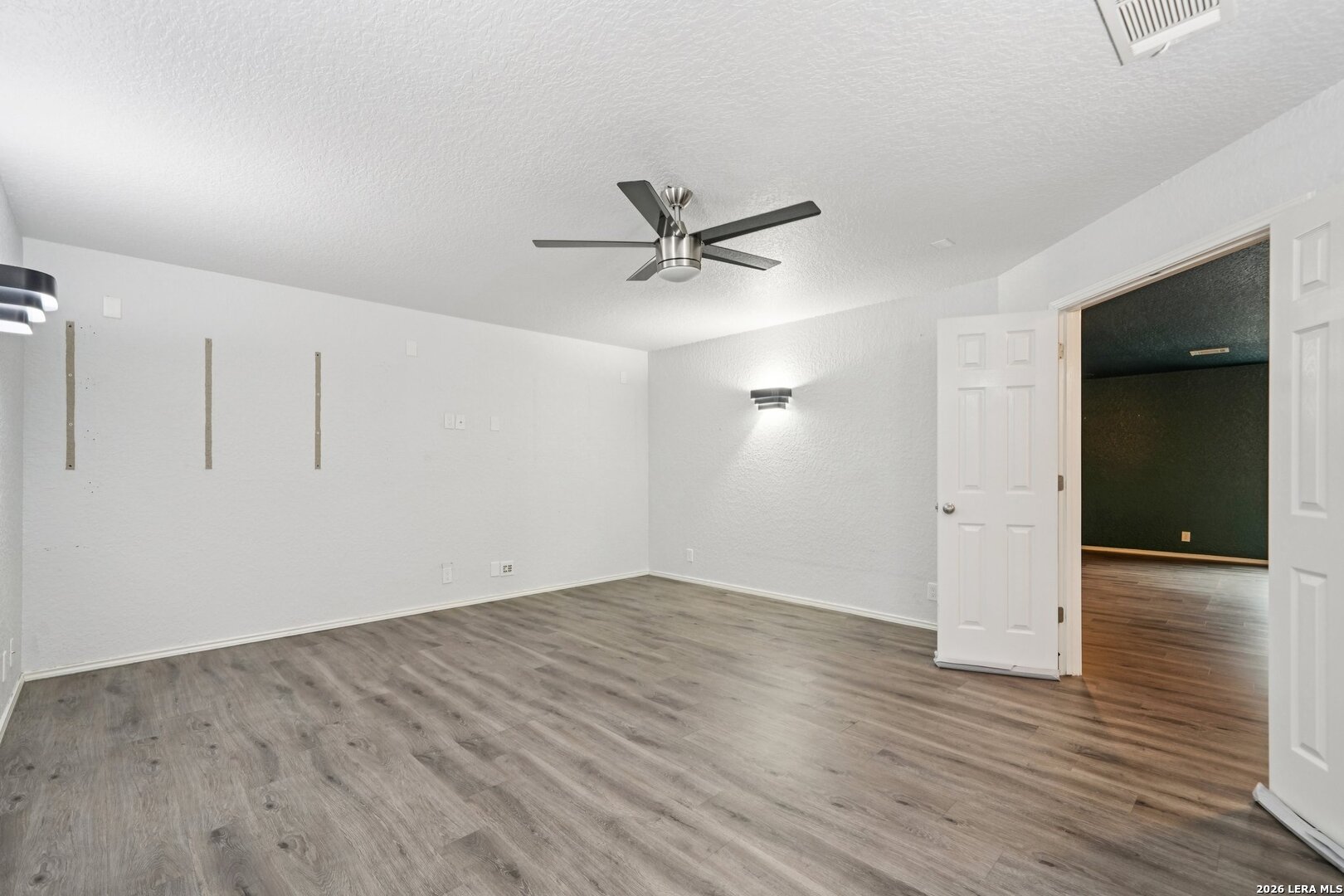 9536 Gold Stage Road San Antonio, TX 78254 - Photo 29 of 39 an empty room with wooden floor and a ceiling fan