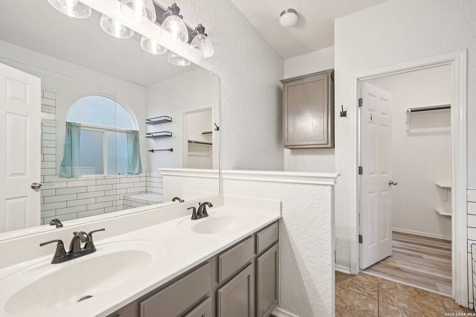 9536 Gold Stage Road San Antonio, TX 78254 - Photo 32 of 39 a bathroom with a sink double vanity and a mirror