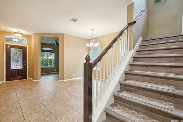 a view of an entryway with wooden floor and a living room