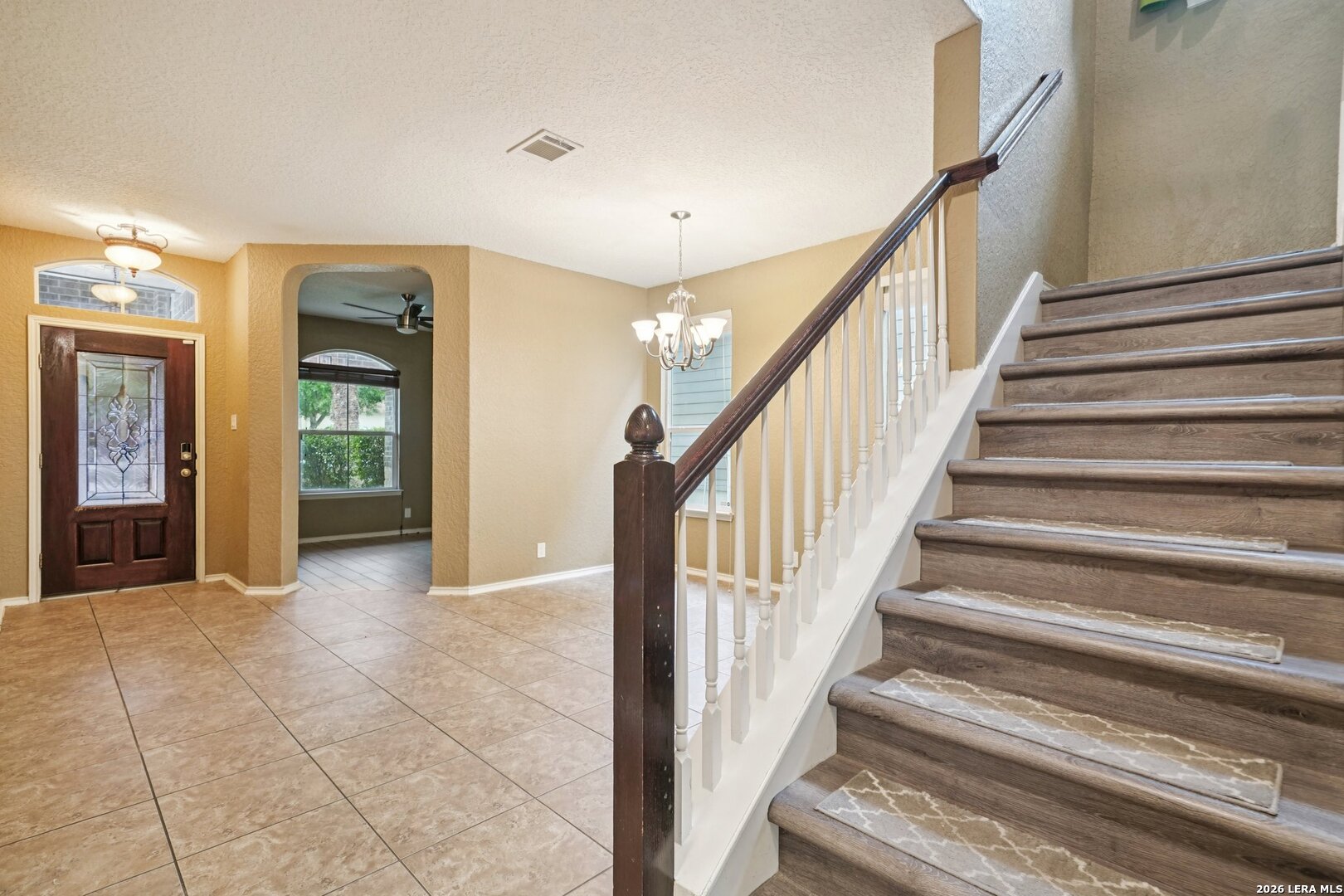 9536 Gold Stage Road San Antonio, TX 78254 - Photo 4 of 39 a view of an entryway with wooden floor and a living room