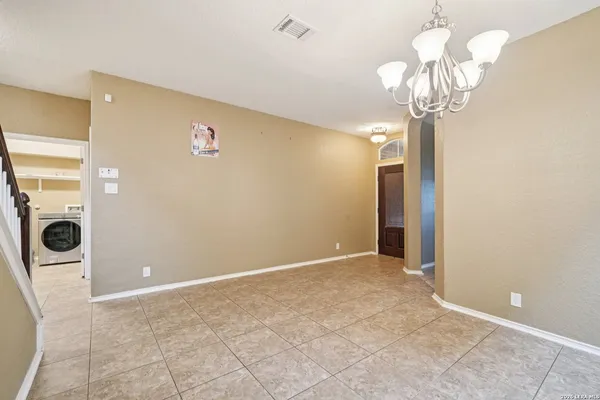 a view of a hallway with a chandelier