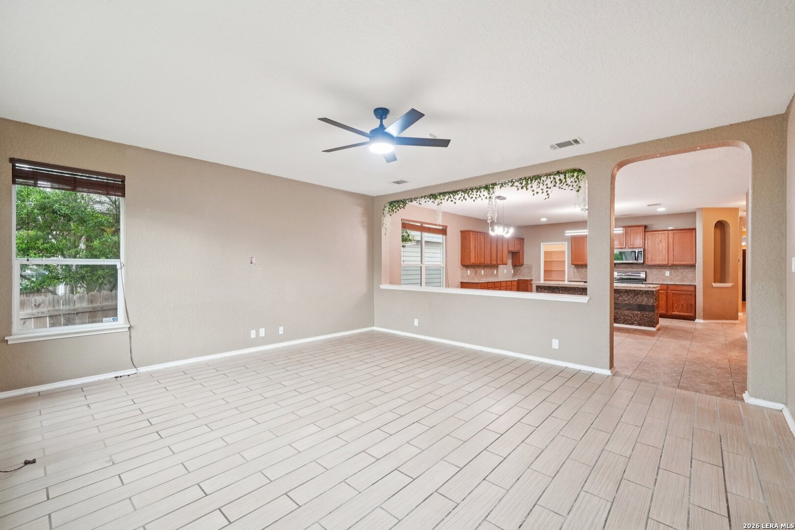 9536 Gold Stage Road San Antonio, TX 78254 - Photo 9 of 39 a view of an empty room with window and wooden floor